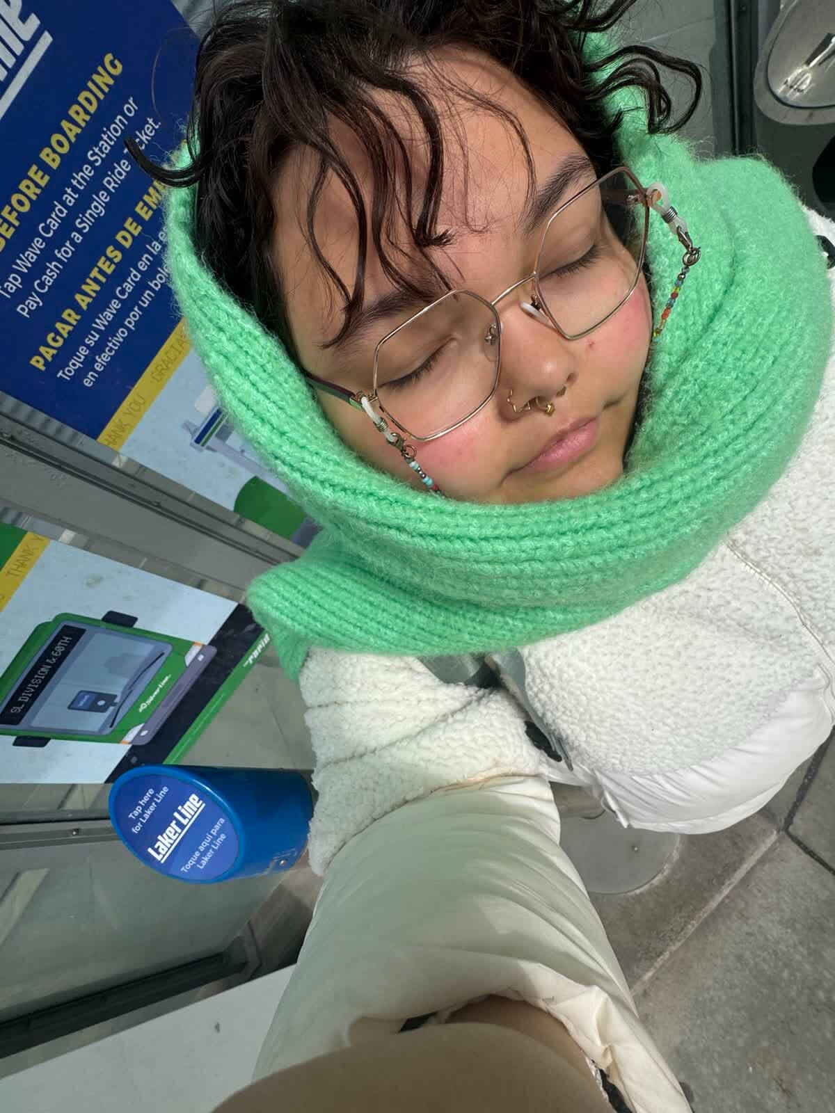 Charlee in large hexagonal glasses and a mint green scarf